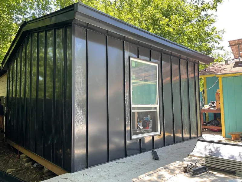 Black standing seam metal wall panels for Roof Inspection in Highlands Ranch