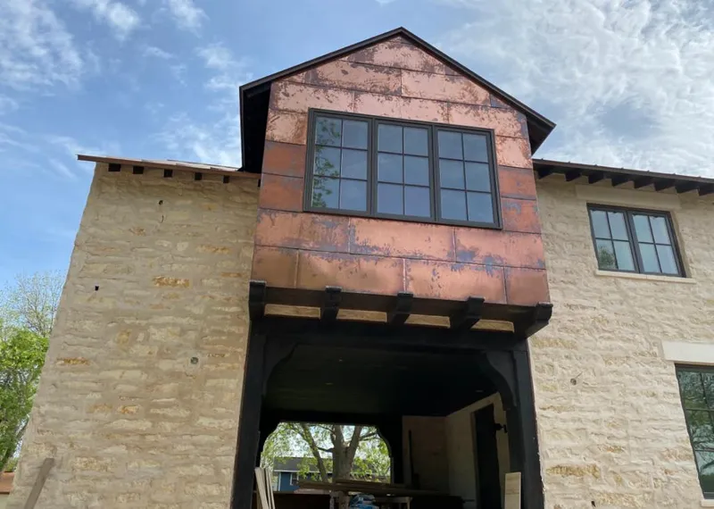 Copper metal panel facade on a stone building for Skylight Installation in Highlands Ranch